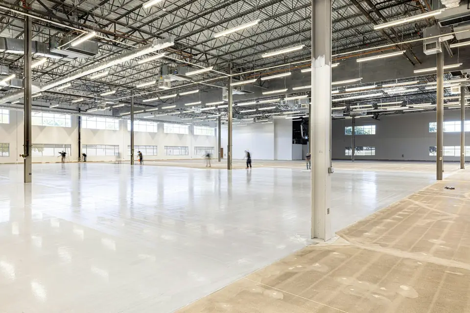 Diamond-ground concrete with visible grinder swirl marks next to a freshly applied glossy epoxy coat (stock photo)