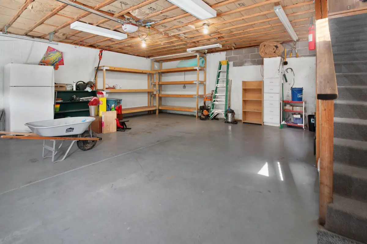 Typical residential garage with a stained, worn bare concrete floor before any coating (stock photo)