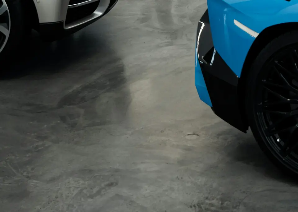 Smooth polished gray concrete floor in a car showroom with soft reflections (stock photo)